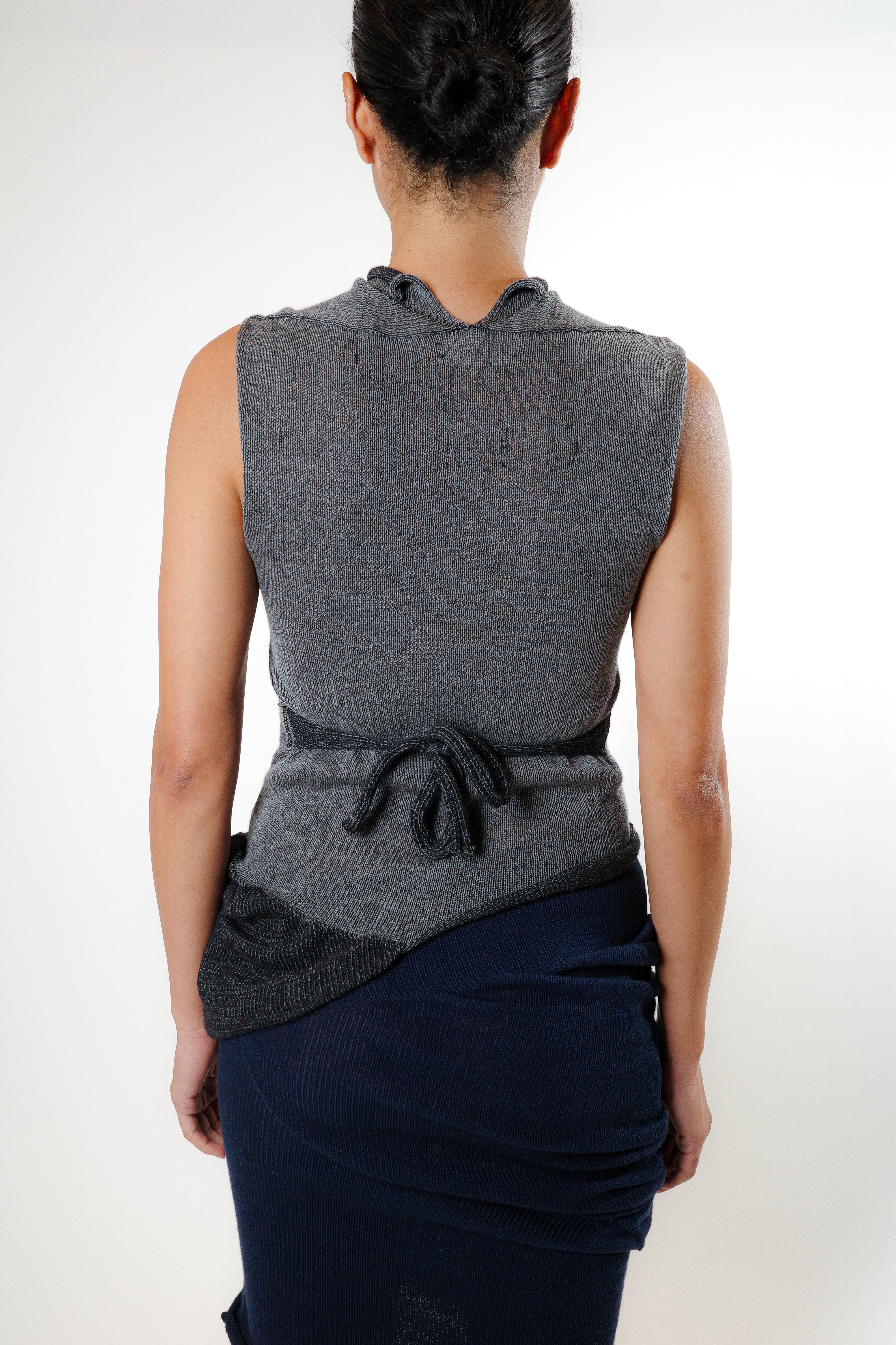 Back view of grey knit top with adjustable ties and reversible construction