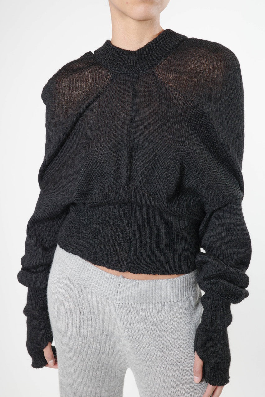 Black knit hoodie with triangular drape, ribbed waist, and ribbed sleeve hems, mid length view