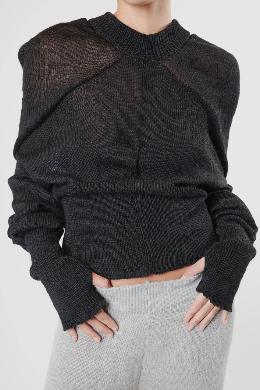 Black knit hoodie with triangular construction, draped front detailing, and ribbed waist